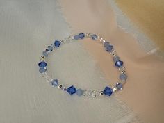 A luxurious, eye-catching, handmade stretch bracelet made using high-quality, lead-free, glass-cut crystals - made in the Czech Republic - renowned for their superior level of sparkle and brilliance.  Your something blue for your wedding day * This bracelet is so sparkly & will be sure to draw attention. The bracelet looks beautiful either on its own or stacked with others. The bicone shape, paired with the variety of finishes on the beads create a unique and super sparkly effect. This bracelet Elegant Adjustable Blue Crystal Bracelet, Blue Crystal Bracelet With Faceted Beads, Blue Faceted Crystal Bracelets, Elegant Blue Hand-strung Crystal Bracelet, Elegant Blue Stretch Bracelet With Faceted Beads, Adjustable Sapphire Bracelets For Wedding, Elegant Blue Crystal Beaded Bracelets, Adjustable Faceted Blue Crystal Bracelet, Adjustable Blue Crystal Bracelet For Wedding