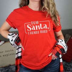 This Funny Christmas short Sleeve tee fits like a well-loved favorite. A great gift for anyone who has a quirky sense of humor or even yourself. Ideal for any situation, a unisex jersey made of soft cotton with a ribbed knit collar will retain its shape even after washing. The shoulders are tapered for a better fit, no itchy seams and has a tear-away label to minimize skin irritation. Easy to layer, breathable, perfect for active and leisure wear. All T-shirts are made to order. They will ship w Funny Holiday T-shirt With Graphic Print, Fun Red T-shirt With Letter Print, Funny Print T-shirt For Christmas Gift, Graphic Tee Crew Neck T-shirt As Gift, Fun Red T-shirt, Christmas Cotton T-shirt Gift, Funny Red Pre-shrunk Tops, Casual Christmas T-shirt As Gift, Novelty Letter Print T-shirt As Gift