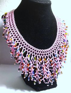 A handmade glass beaded necklace that is perfect for any occasion: parties, holidays, birthdays, anniversaries. All products are hand-crafted by my mother. Dimensions: - Actual Length: 30.0 cm - Collar Length: 22.0 cm - Width: 14.0 cm - Height: 2.0 cm Lightweight, high quality with a beaded toggle as a clasp. Will respond to concerns and suggestions promptly. Acrylic Pearls: 8 mm. Shipping costs: Free Domestic Shipping. All orders are sent by air-mail with tracking number. Time of delivery: Estimated 1-3 days for domestic shipping; international make take 7-14 days. Feel free to check out our other similiar products! Link: https://www.etsy.com/shop/NurKnitsNKrafts Handmade Beaded Necklaces With Round Beads For Celebration, Handmade Glass Beads For Jewelry Making, Unique Bead Caps For Gifts, Glass Beaded Necklaces With Dangling Beads As Gifts, Artisan Pink Necklace With Colorful Beads, Pink Necklaces With Large Beads For Festivals, Pink Necklace With Large Beads For Festivals, Artisan Beaded Necklaces With Bead Caps For Gifts, Pink Beaded Necklaces With Round Beads For Crafting