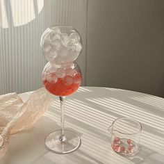 a glass filled with liquid sitting on top of a table