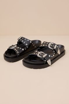 The Devaney Black Studded Western Buckle Slide Sandals were made for effortless styling, so you can spend more time out in the sun having fun! These faux leather sandals feature an almond-shaped footbed and wide adjustable straps embellished with silver studded details and Western-inspired buckles and tips with intricate embossing. A contoured insole completes the simple slide-on design. 0. 75" rubber sole. Smooth insole. Rubber sole has nonskid markings. Man made materials. Imported. Lulus | De Flat Slingback Sandals With Buckle For Summer, Flat Slingback Sandals With Buckle Closure For Summer, Closed Toe Footbed Sandals With Adjustable Strap For Vacation, Summer Slingback Sandals With Buckle Closure, Leather Footbed Sandals For Summer, Closed Toe Footbed Sandals With Buckle For Vacation, Summer Sandals With Leather Footbed And Round Toe, Summer Leather Slingback Sandals With Buckle Closure, Flat Heel Footbed Sandals With Buckle Closure For Vacation