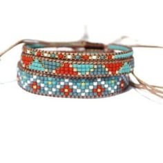 three bracelets with different colored beads and tassels on each one, the beaded