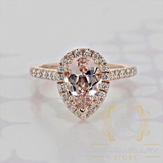 an engagement ring with a pink diamond in the center and white diamonds on the sides