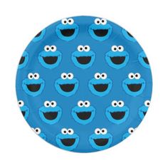 a blue paper plate with sesame the cookie monster faces on it, and black eyes