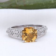 a fancy yellow diamond ring with filigree accents