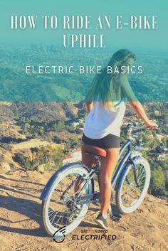 a woman riding a bike on top of a hill with the words how to ride an e - bike uphill electric bike basics