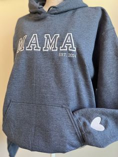 This personalized sweatshirt with children(s) names on the sleeve is so precious. The embroidery is not only beautiful and unique, it will be treasured for many years to come! These make a great gift for you, her, grandma gift, new mom gift, bride, wife... or save them for a perfect Christmas gift! Font of the embroidery will be as pictured & all letters across the chest will be automatically capitalized (this cannot be changed). Hoodie: Unisex True to size -Size Up for an oversized Fit! Model - Personalized Long Sleeve Hoodie For Gift, Customizable Hooded Hoodie For Gift, Customizable Hooded Hoodie As Gift, Casual Personalized Hooded Hoodie, Cotton Hooded Hoodie For Gift, Cotton Hooded Hoodie As Gift, Cotton Hooded Sweatshirt For Mother's Day, Personalized Long Sleeve Cotton Hoodie, Personalized White Cotton Hoodie