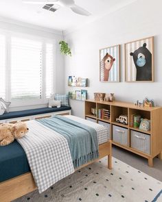 a bed room with a neatly made bed next to a window and a book shelf