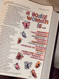 an open book with words and butterflies on the pages that read a godly woman is