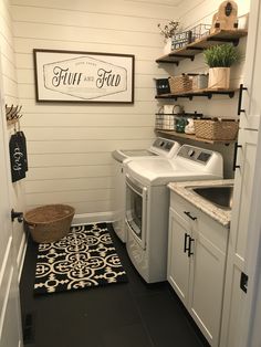 a washer and dryer in a small room next to a door with open shelves