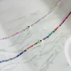 Cute Multicolor Beaded Necklaces With Heart Beads, Cute Heart Beaded Necklaces With Round Beads, Cute Multicolor Heart Beads Beaded Necklace, Trendy Multicolor Beaded Necklaces With Heart Beads, Trendy Handmade Heart Beaded Necklaces, Cute Beaded Necklaces With Heart-shaped Beads, Colorful Beaded Heart Jewelry, Dainty Beaded Necklace With Heart And Round Beads, Handmade Dainty Heart-shaped Beaded Necklace