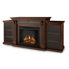 an entertainment center with a fire place and bookcases on both sides, in dark wood