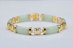 The Killiney Ladies Link Bracelet in 14K Gold set with Jade. Crafted in 14 karat yellow gold, this gem set bracelet is set with alternating sections of jade and yellow gold. Measuring a standard 7 inches in length, this bracelet features a hidden box style clasp with added safety hook. Each piece has been hand selected and meticulously identified and graded by a Graduate Gemologist who has been awarded a degree by the Gemological Institute of America (GIA). Please visit our Shop's About Page or Classic Jade Bracelets For Formal Occasions, Luxury Jade Bracelets For Formal Occasions, Formal Gold Jade Bracelets, Luxury Formal Jade Bracelets, Luxury Jade Beaded Bracelets, Formal Yellow Gold Jade Bracelets, Formal Yellow Gold Jade Bracelet, Yellow Gold Jade Bracelets For Gift, Elegant Gold Jade Bracelets