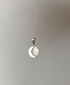 This sterling silver pendant with a crescent moon is a unique, handmade piece. Each moon has its own special shape, so no two are alike. If you prefer a specific position for the moon, please let me know. Additionally, the silver chain is adjustable, allowing you to wear it at your preferred length between 40 and 45 cm. It's the perfect accessory to add a special touch to your unique style. We use the highest quality silver, ethically sourced from European mines, to make this pendant. Made in Barcelona ---If you have any questions, write to me and I will be happy to assist you.---" Dainty Silver Moon Shaped Jewelry, Sterling Silver Moon Engraved Necklace, Sterling Silver Moon Shaped Engraved Necklace, Sterling Silver Moon Charm Pendant Necklace, Sterling Silver Pendant Necklace With Moon Charm, White Sterling Silver Necklace With Moon Charm, Silver Moon Charm Pendant Jewelry, Silver Celestial Necklace 925, Silver Celestial Necklace Stamped 925