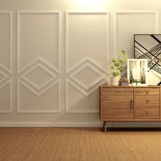 an empty room with a wooden cabinet and white wallpaper on the walls, along with a plant in a vase