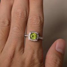 This is a gorgeous handmade creation. Its beauty is its simplicity & Elegance. The 7*7mm round cut natural peridot is crafted in solid sterling silver and with rhodium plated. It is available to customized, if you have any mind, just let me know, we will discuss with it. All item is sent in a beautiful gift box You can realize more lovely stuff clicking the link https://www.etsy.com/shop/knightjewelry?refshopsection_shophome_leftnav Please leave the correct address and you PHONE NUMBER for d May Birthstone Ring With Halo Setting, May Birthstone Round Halo Ring, Round May Birthstone Halo Ring, Green Birthstone Ring With Halo Setting, Round Halo Ring With May Birthstone Gemstone, Green Birthstone Ring With Round Gemstone, Green Diamond Ring Gift, Green Gemstone Birthstone Ring, Green Gemstones For Promise Rings