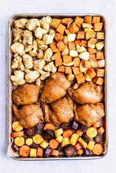 a tray filled with chicken, sweet potatoes and carrots