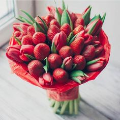 a bouquet of strawberries in front of a window