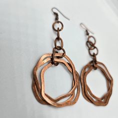 These unique vintage copper dangle earrings are the perfect touch of boho chic to any outfit, these earrings make a statement while adding a touch of elegance. Stand out from the crowd and add these must-have earrings to your collection today! Vintage Copper Dangle Details: vintage copper design 3 copper rings denim perfect great gift idea boho chic 3" drop Bohemian Rose Gold Dangle Jewelry, Nickel-free Bronze Chandelier Earrings, Handmade Copper Drop Earrings, Hand Forged Copper Dangle Hoop Earrings, Nickel Free Copper Chandelier Earrings As Gift, Hand Forged Copper Hoop Earrings With Dangle, Nickel-free Rust Drop Earrings, Nickel-free Copper Chandelier Earrings As Gift, Single Copper Drop Earring