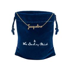 a blue velvet bag with the name jacquetine on it and a gold chain