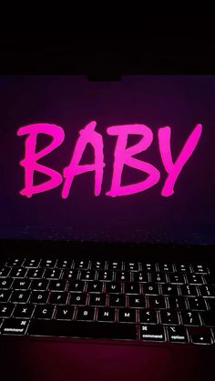 a laptop computer with the word baby painted on it's keyboard in front of a dark background