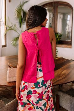 – All eyes are sure to be on you when you arrive in this darling top – Blended rayon and linen material in a layered design – Round neckline and an open back with two tie closure – Sleeveless 3-inches shoulder straps – Flattering silhouette that ends in subtle curved hemline Spring Linen Tops With Tie Back, Spring Linen Tie Back Tops, Spring Linen Tie-back Top, Casual Linen Tie-back Tops, Spring Vacation Blouse With Tie Back, Summer Vacation Blouse With Tie Back, Chic Tie-back Top For Brunch, Chic Tie Back Top For Brunch, Chic Brunch Tie Back Top