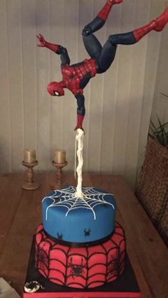 a spiderman cake on top of a wooden table