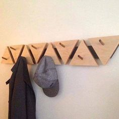 a coat rack and hat hanger on the wall