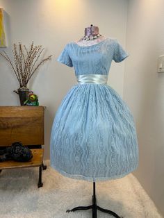 1950s dress / 50s dress / 1950s fit and flare / 1950s fit and flare  dress / 1950s fashion  This 1950s dress is stunning and has a gorgeous lace fabric on top of a shiny fancier which creates this matte shine. She has the classic fit and flare cut with the nipped waist, and a full skirt. She has a metal zipper in the back. Measurements provided are flat and have been doubled.  Bust 32"  Waist 26"  Hips free"   Length 38.5" Shoulders 13" ❤️ Condition: Excellent vintage condition. Flaw: The back of the skirt has a light black smudge mark. It's hard to see in the common if the skirt, but please see heavily lit photo. Ribbon used in photos not included. This item has been cleaned and is ready to wear. $148 includes domestic shipping and insurance. International shipping is $30. Please let me k Vintage Fashion Tea Length Dress With Fitted Bodice, 1950s Style Fitted Tea Length Dress, 1950s Style Fitted Tea Length Vintage Dress, Fitted Tea Length Dress In 1950s Style, Tea Length Dress With Fitted Bodice For Vintage Fashion, 1950s Style Dress With Fitted Bodice For Vintage Events, Fitted 1950s Style Dresses For Vintage Events, Vintage Event Dresses With Fitted Bodice And Short Sleeves, 1950s Style Fitted Tea Length Midi Dress