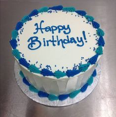 a birthday cake with the words happy birthday written in blue frosting on top of it