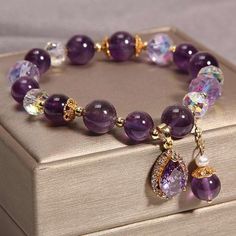 Elevate Your Style with the Enchanting Natural Amethyst and Water Drop Pendant Bracelet Embrace the Essence of Elegance and Tranquility: Discover the timeless beauty and calming energy of our Natural Amethyst and Water Drop Pendant Bracelet. Crafted from high-quality natural amethyst, this exquisite bracelet is a harmonious blend of alternating purple and white hues. Its layered richness offers an ever-evolving aesthetic, ensuring you'll cherish it for years without it ever feeling mundane. Experience the Healing Touch: Amethyst, a renowned healing stone, carries properties known to alleviate anxiety, sharpen focus, and enhance sleep quality. This bracelet isn't just a stunning accessory; it's a wellspring of positive energy, symbolizing wisdom, courage, and loyalty. It's a talisman of tra Elegant Amethyst Crystal Bracelet With Stones, Elegant Amethyst Crystal Bracelet For Jewelry Making, Spiritual Amethyst Necklaces With Natural Stones, Evolving Aesthetic, Healing Amethyst Necklaces With Polished Beads, Spiritual Amethyst Jewelry With Polished Beads, Healing Touch, Purple And White, Water Drop