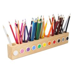 a wooden pencil holder filled with lots of colored pencils