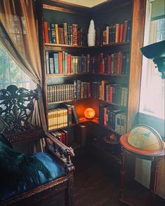 a room with bookshelves full of books and a lamp