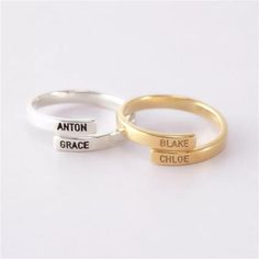 two gold and silver rings with names on them