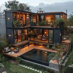 an aerial view of a house made out of shipping containers and surrounded by greenery