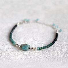 "Raw Apatite and Shaded Blue Tourmaline Bracelet. October birthstone gift. Skinny, Boho Style Multi Gemstone Bracelet.  Created using beautiful, micro faceted  shaded Tourmaline beads, paired with stunning, aqua blue, raw Apatite stone and a bright, shiny sterling silver or 14k gold filled spacer beads. These natural AA grade  Tourmaline beads are gorgeous - beautiful ombre shades of pale and dark, almost black blue which are emphasised by their tiny facets.  This multi gemstone bracelet is adjustable in size, between 5.5\" - 8\".  The 2.5\" extension chain is decorated with few dangling, faceted, aqua blue apatite gemstone beads. This natural gemstone bracelet looks amazing on its own or layered with other bracelets. A beautiful addition to your individual, bohemian style. Natural gemston Apatite Bracelets With Natural Stones In Round Beads, Apatite Natural Stone Bracelets As Gift, Tourmaline Bracelets With Natural Stones, Blue Spiritual Bracelets With Birthstone, Spiritual Blue Birthstone Bracelets, Adjustable Tourmaline Gemstone Bracelets, Adjustable Tourmaline Gemstone Bracelet, Tourmaline Natural Stones Bracelets As Gift, Turquoise Apatite Spiritual Bracelets