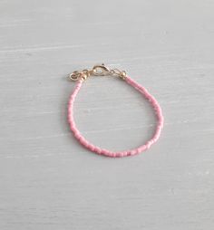 "If you would like to add gold filled hardware to a bracelet, please use this link to purchase it along with the bracelet. You will need to purchase one for EACH bracelet you would like to add gold filled hardware to. https://www.etsy.com/LittleLovliesShop/listing/860546443/gold-filled-upgrade?utm_source=Copy&utm_medium=ListingManager&utm_campaign=Share&utm_term=so.lmsm&share_time=1598757365437 Dainty Pink Bracelet. Your choice of gold or silver clasp and fittings. Perfect for al Adjustable Gold Bracelet With Tiny Beads, Adjustable Pink Gold Bracelets With Round Beads, Adjustable Pink Gold Bracelet With Round Beads, Dainty Pink Jubilee Bracelet, Adjustable Pink Chain Bracelet Gift, Pink Adjustable Chain Bracelet Gift, Adjustable Pink Chain Bracelet, Dainty Hypoallergenic Pink Bracelets, Adjustable Pink Bracelet With Extender