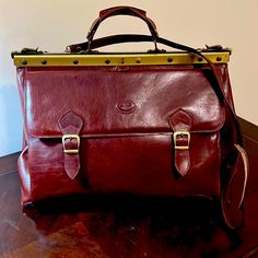 Vintage Leather Doctor’s Bag Made In Florence, Italy. Vegetable Tanned With A Stunning Patina. One Large Side Pocket, One Zippered Compartment. New, Never Used, Pristine Condition. Designer Burgundy Satchel For Everyday Use, Burgundy Top Handle Satchel For Business, Red Leather Lined Satchel Bag, Red Leather Lined Satchel For Formal Occasions, Red Briefcase For Formal Use, Red Leather Satchel For Formal Occasions, Business Bags In Burgundy With Detachable Strap, Business Burgundy Satchel With Detachable Handle, Timeless Burgundy Bags For Everyday Use