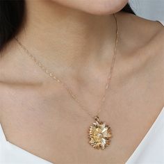 A glimmering mum pendant on a light-catching curb chain necklace is sure to accentuate any neckline. Chain: 17.72" L with 1.96" extender Pendant : 1.26" diameter Lobster claw clasp 18k gold-plated copper Gold Necklace With Flower Pendant And Lobster Clasp, Elegant Yellow Gold Flower Pendant Charm Necklaces, Yellow Gold Pendant Necklace With Hallmarks, Gold-tone Round Pendant Chain Necklace With Lobster Clasp, Tiger Gold Pendant, Style Hip Hop, Curb Chain Necklace, Snake Pendant, Estilo Hip Hop