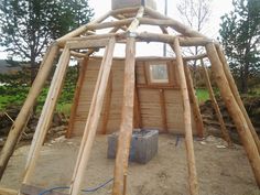 a wooden structure that is being built in the dirt