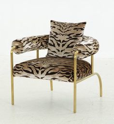 an animal print chair with gold legs and arms