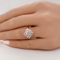 a woman's hand with a diamond ring on it