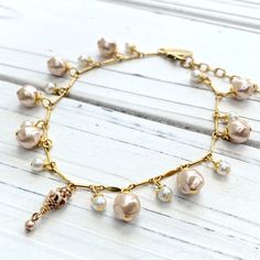 Gold pearl anklet for women with tiny seashell detail and dangling pink synthetic fresh water pearls on gold plated bar chain. Women's boho ankle bracelet that's simple and sophisticated made with high-quality materials. Choice of length with 2" extension on all lengths. Rose Gold Beaded Bracelets With Pearl Charm, Dainty Pearl Gold Anklets, Gold Dainty Anklets With Pearl Charm, Elegant Adjustable Pearl Bracelet With Rose Quartz, Dainty Gold Anklets With Pearl Charm, Rose Gold Pearl Bracelet With Pearl Charm, Gold Pearl Anklet With Pearl Charm, Elegant Shell-shaped Bracelets, Elegant Gold-tone Bracelet With Pearl Charm