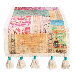 a multicolored rug with tassels hanging from it