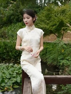 This is a traditional Chinese-style cheongsam in white color with three-quarter sleeves. The cheongsam has a high collar measuring 5.5cm in height and features three rows of buttons. It is available in two lengths: 120cm and 130cm. The fabric used is rayon, and there is no zipper. Size Chart: S: Shoulder width-36cm, Chest-84cm, Waist-68cm, Hip-88cm M: Shoulder width-37cm, Chest-88cm, Waist-72cm, Hip-92cm L: Shoulder width-38cm, Chest-92cm, Waist-76cm, Hip-96cm XL: Shoulder width-39cm, Chest-96cm Summer Wedding Ao Dai With Stand Collar, Traditional Fitted Ao Dai For Summer, Traditional Ao Dai For Tea Ceremony, Traditional Ao Dai For Summer Tea Ceremony, White Short Sleeve Ao Dai For Summer, White Short Sleeve Ao Dai For Spring, White Fitted Cheongsam For Spring, Traditional Cheongsam With Stand Collar For Tea Ceremony, White Fitted Ao Dai For Summer