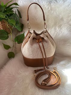 ⭐️Elegant raffia bucket bag suitable for summer. Including an adjustable genuine leather shoulder strap and also its finishes. The bag is made entirely in Italy and is handmade by local artisans. ⭐️Very good quality and beautiful to wear for an everyday look or even for summer evenings for a fresh and young look. 👜DIMENSIONS: Length 20cm Height 23 cm Thickness at the base 12 cm Chic Bucket Bag With Braided Handles As Shoulder Bag, Chic Shoulder Bucket Bag With Braided Handles, Chic Brown Woven Leather Bucket Bag, Brown Bucket Bag With Braided Handles For Beach Season, Brown Shoulder Bucket Bag For Beach Season, Summer Brown Bucket Shoulder Bag, Summer Brown Shoulder Bucket Bag, Brown Bucket Bag For Everyday Beach Use, Brown Bucket Bag With Adjustable Strap For Vacation