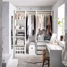 a white closet filled with lots of clothes