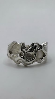 The fluid metal custom molten ring is a subtle and elegant addition to your ring stack. You can choose any word or letter combination (preferably under 6 characters due to space constraints). Whether it's your own name, a cheeky phrase or your partner's initials, let's make it happen! Each piece is one of a kind and meticulously hand carved from wax by me on the Sunshine Coast, Australia - I ship worldwide. PERSONALISED RING SPECIFICATIONS Metal: Recycled 925 sterling silver. Custom: Add your cu Melting Metal For Jewelry, Molten Metal Aesthetic, Wax Jewelry Carving, Unique Silver Stackable Rings With Polished Finish, Silver Stackable Rings With Polished Finish, Artistic Hand Cast Sterling Silver Rings, Artistic Sterling Silver Ring, Artistic Sterling Silver Ring In Silver, Artistic Sterling Silver Rings In Silver Color