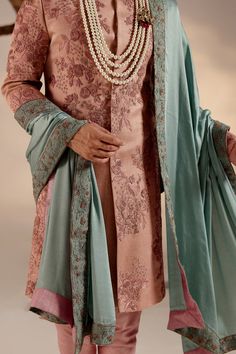 Orchid Pink Sherwani | Jatin Malik Introducing our stunning orchid pink sherwani, a true masterpiece of elegance and sophistication. This sherwani is adorned with intricate hand embroidery details, featuring shades of pink and zari that create a mesmerizing visual impact. Each stitch is meticulously crafted to enhance the richness of the design, making this ensemble a work of art. Perfect for those who appreciate refined craftsmanship and timeless style, this orchid pink sherwani is sure to make a statement at any special occasion or event. Included in purchase: Sherwani, Kurta, Churidar, Safa Product Specification Color: Dark pink Fabric: Linen silk Occasion: Engagement, Wedding, Bridal, Reception Style: Sherwani, Kurta, Churidar, Safa Care: Dry Clean Work: Hand Embroidery Customization o Pink Kurta With Chikankari Embroidery For Reception, Pink Chikankari Embroidery Kurta For Reception, Pink Traditional Churidar For Transitional Season, Transitional Pink Churidar With Traditional Drape, Pink Kurta For Eid Reception, Traditional Long Sleeve Pink Bandhgala, Traditional Pink Long Sleeve Bandhgala, Formal Pink Kurta With Naqshi Detailing, Pink Kurta For Reception And Transitional Season