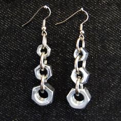 pair of silver chain earrings on black fabric